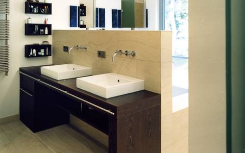 Bild: Ein elegante Badezimmer mit abgetrennter Badewanne und modernem Waschtisch